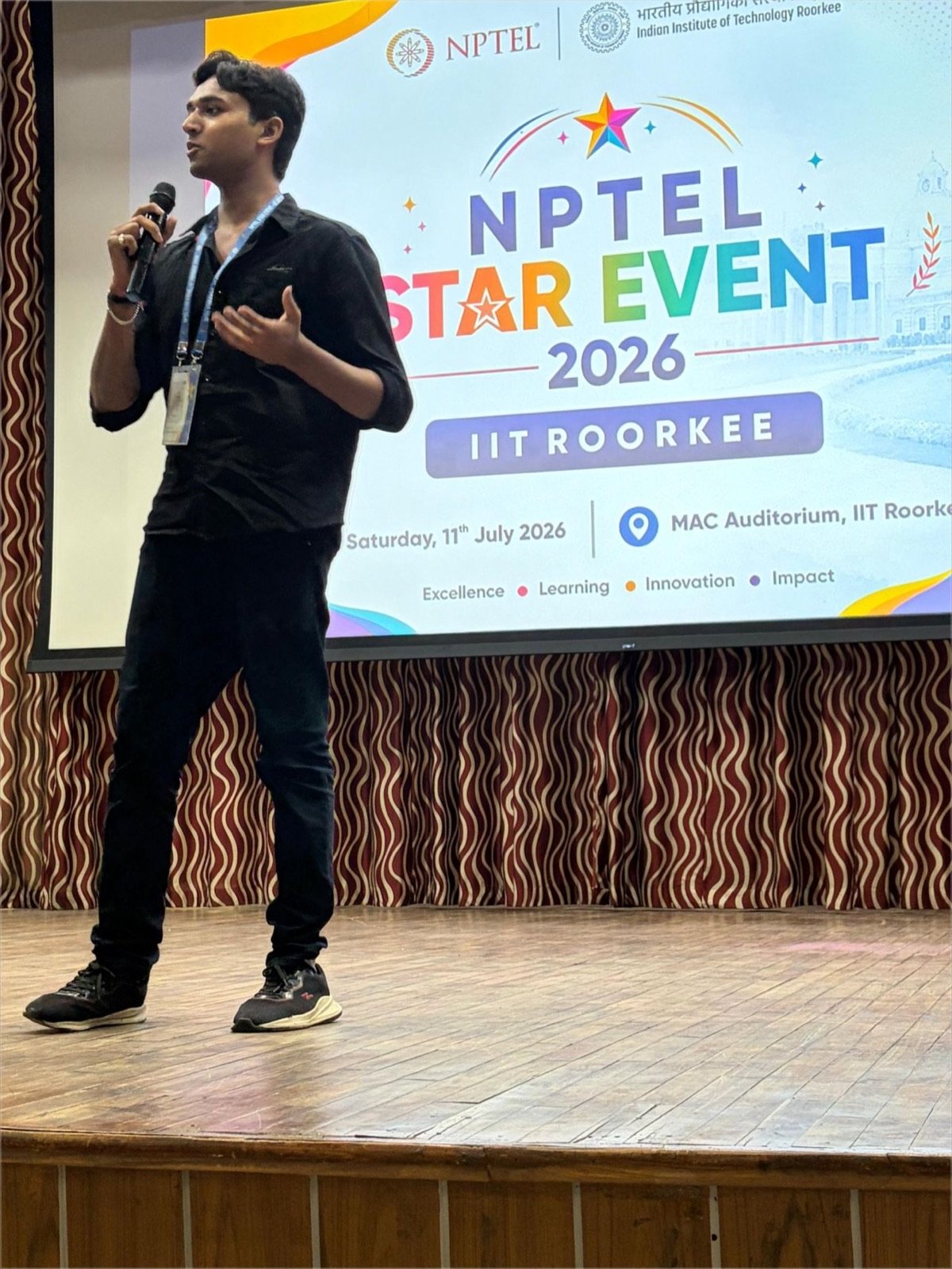Chirag Jain speaking on stage at the NPTEL STAR Event 2026 in the MAC Auditorium, IIT Roorkee