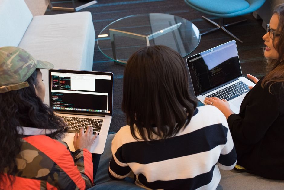 Students working on laptops at a hackathon