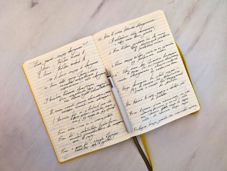Handwritten study notes and past papers on a desk